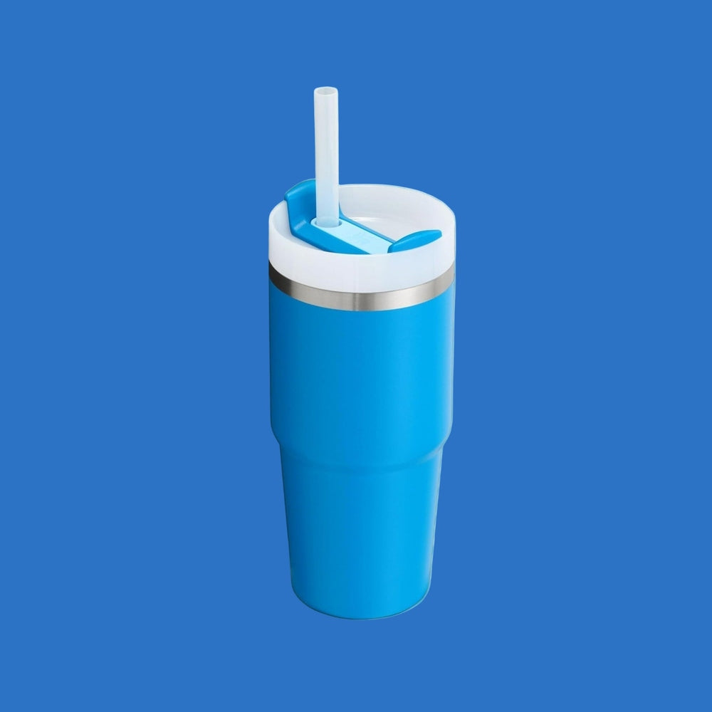 STANLEY The Quencher H2.0 Flowstate Tumbler With Handle 14 oz in blue with white lid and straw inserted.