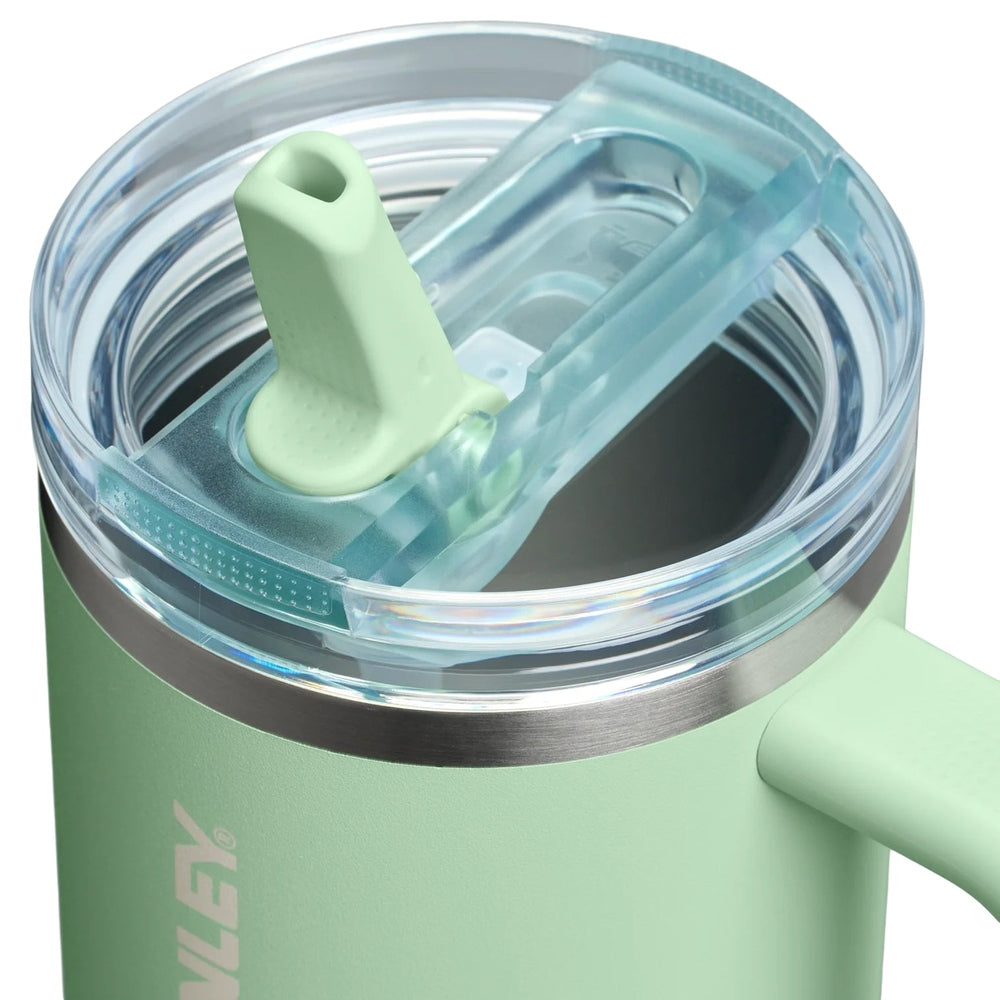 Stanley The Quencher Protour Flip Straw Tumbler 40 oz in mint green with a flip straw lid in use.
