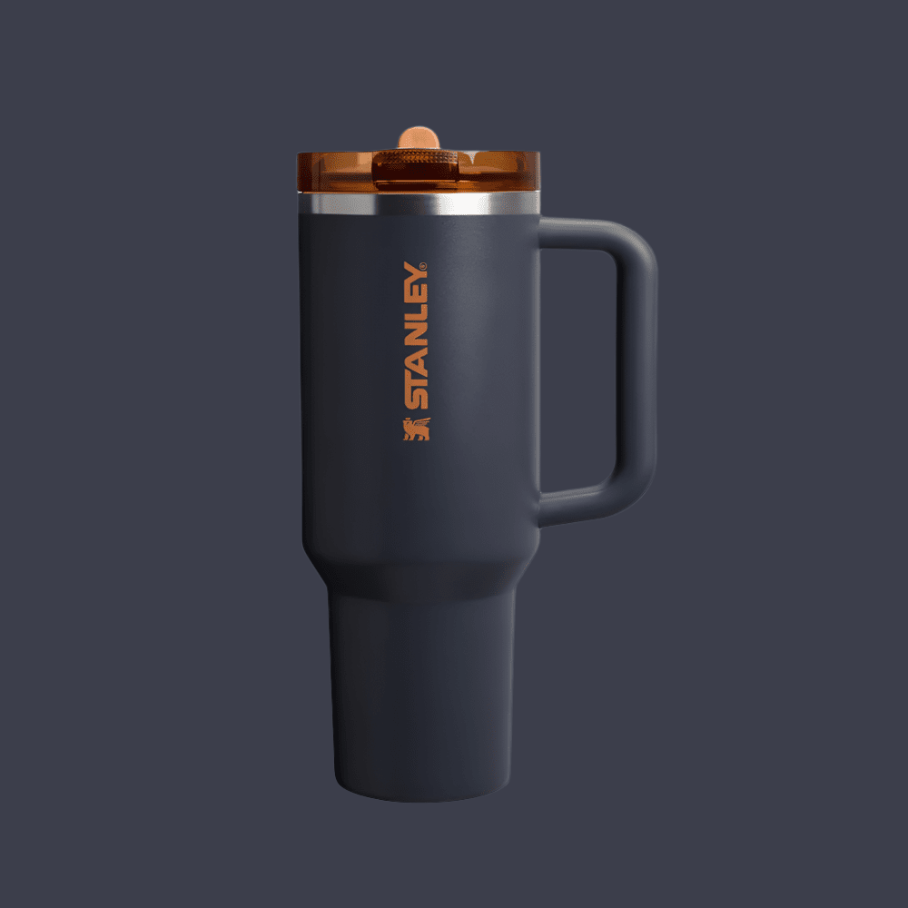 Stanley Quencher ProTour 40 oz tumbler with flip straw, navy body, orange logo, amber lid