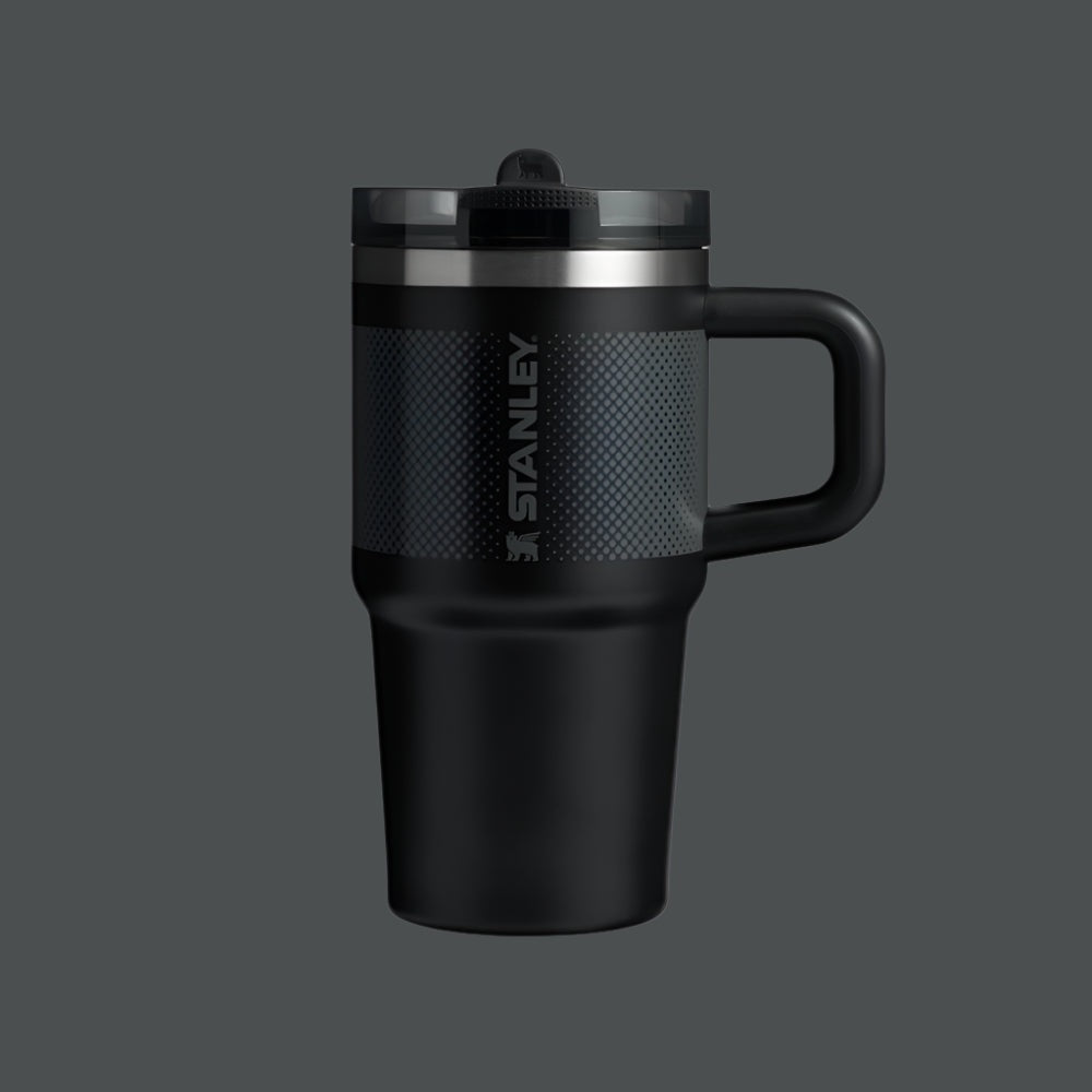 Stanley Quencher ProTour Flip Straw Tumbler 20 oz in black, textured grip and integrated handle shown ready for travel