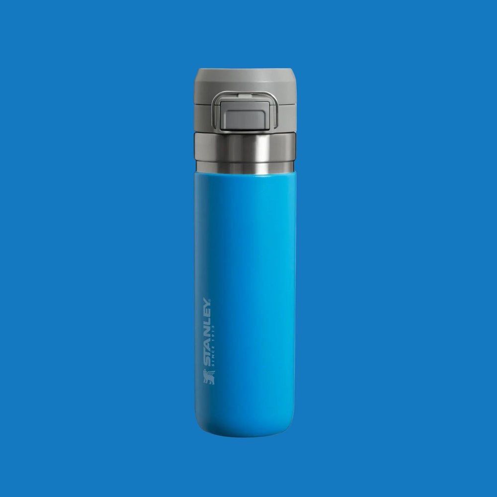 Stanley The Quick Flip GO Bottle 24 oz blue insulated bottle with a gray flip-top lid, lid snapped shut.