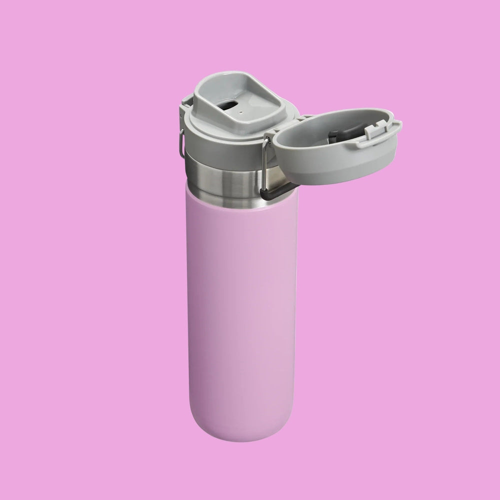 STANLEY The Quick Flip GO Bottle 24 oz in pink with gray flip-top lid swung open to reveal the spout.