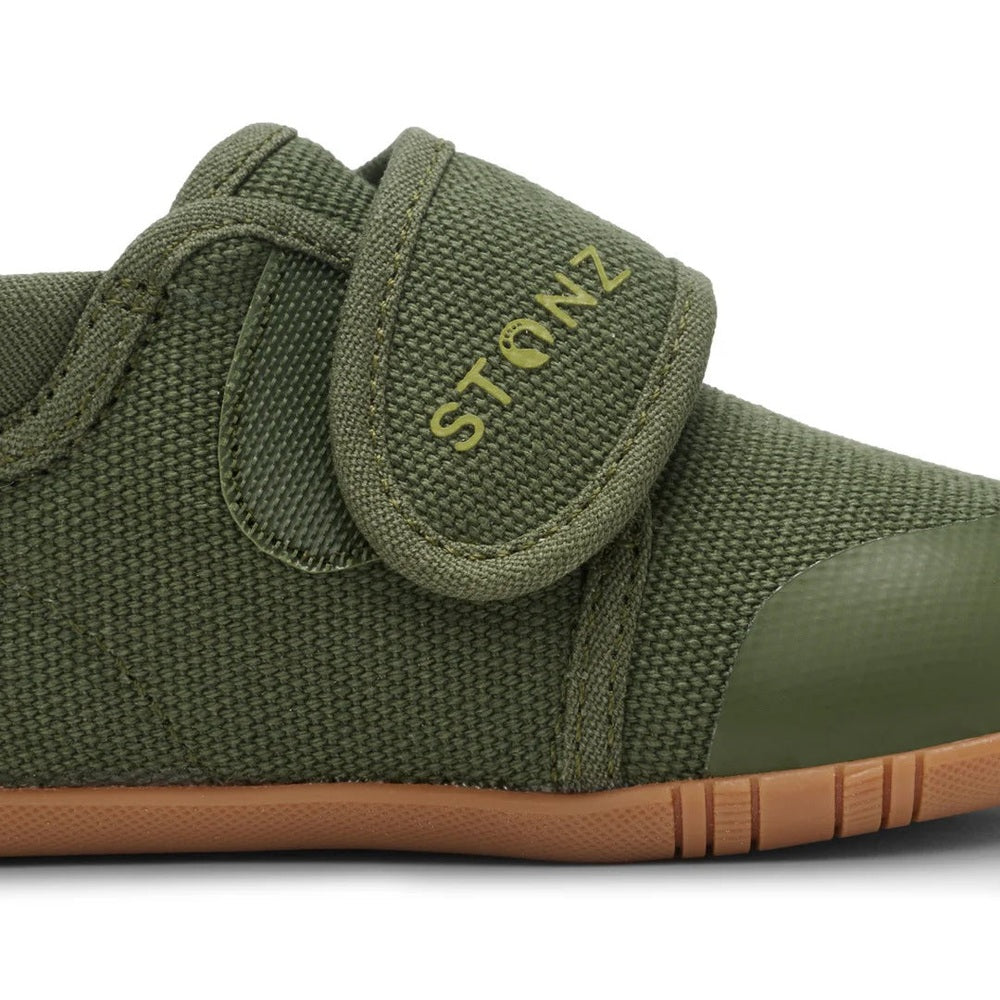 Stonz Cruiser Natural Baby Shoes Cypress in olive green with Velcro strap fastened and gum sole visible.