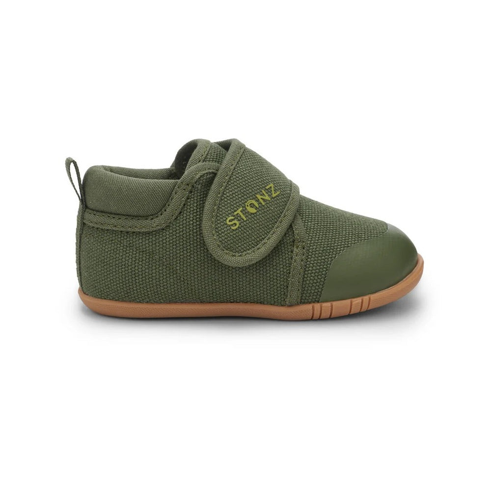 Stonz Cruiser Natural Baby Shoes Cypress in olive-green canvas with Velcro strap fastened, rubber toe, tan sole.