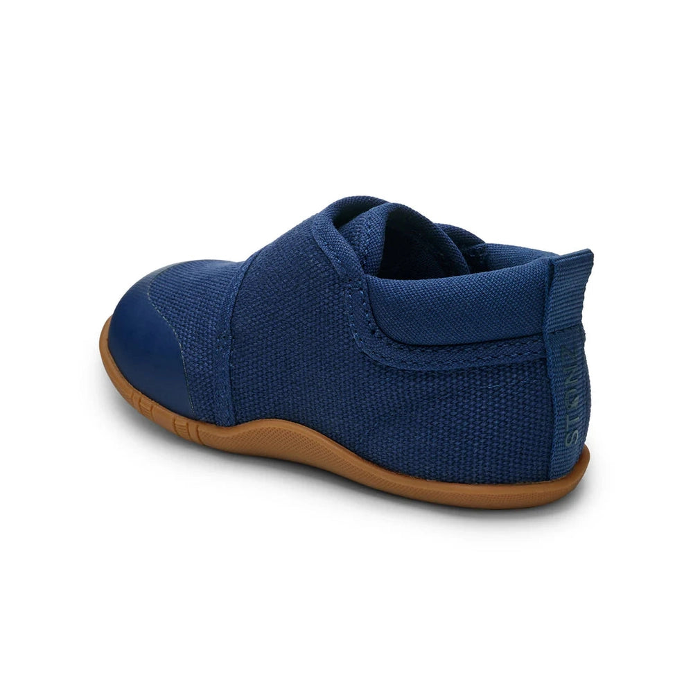 STONZ Cruiser Natural Baby Shoes Navy; navy fabric sneaker with Velcro strap and tan outsole on a white background.