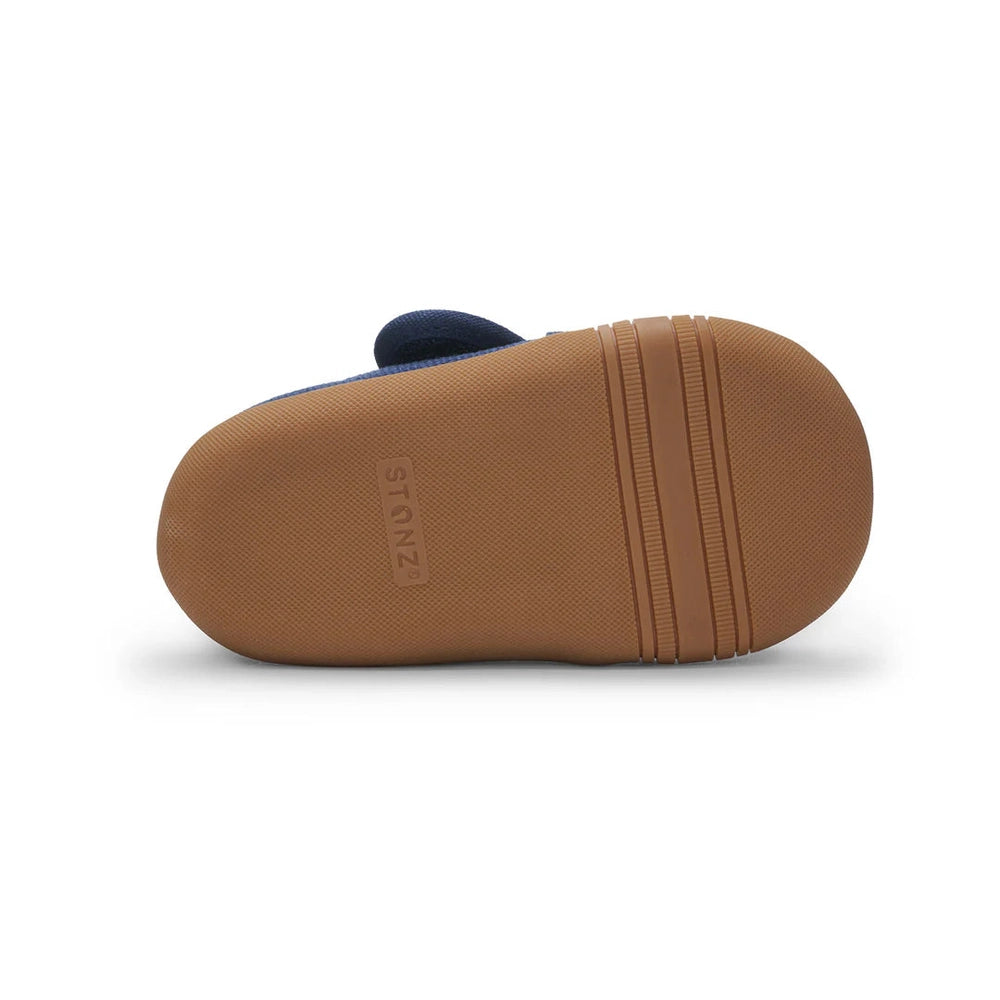Stonz Cruiser Natural Baby Shoes Navy shown from bottom, featuring a tan textured sole with grip lines.