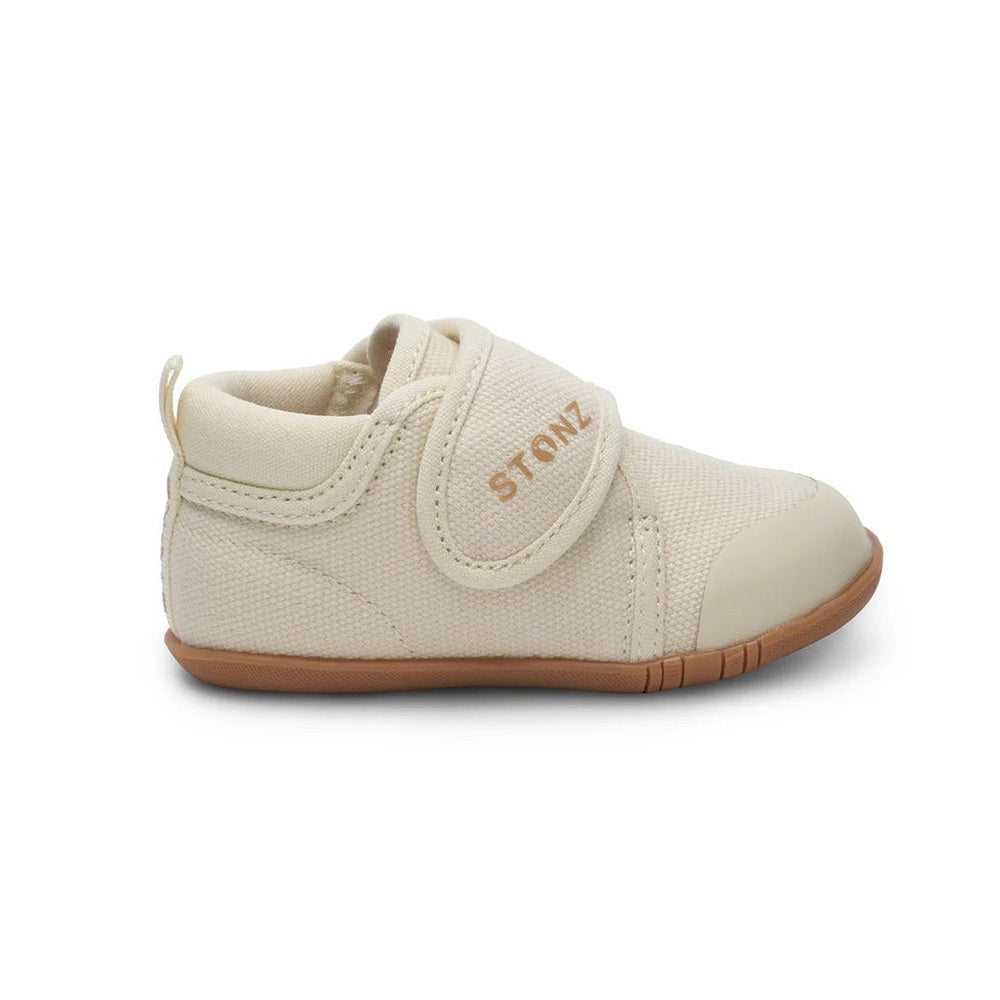 Stonz Cruiser Natural Baby Shoes Oatmeal with Velcro strap fastened, cream fabric upper and brown sole.