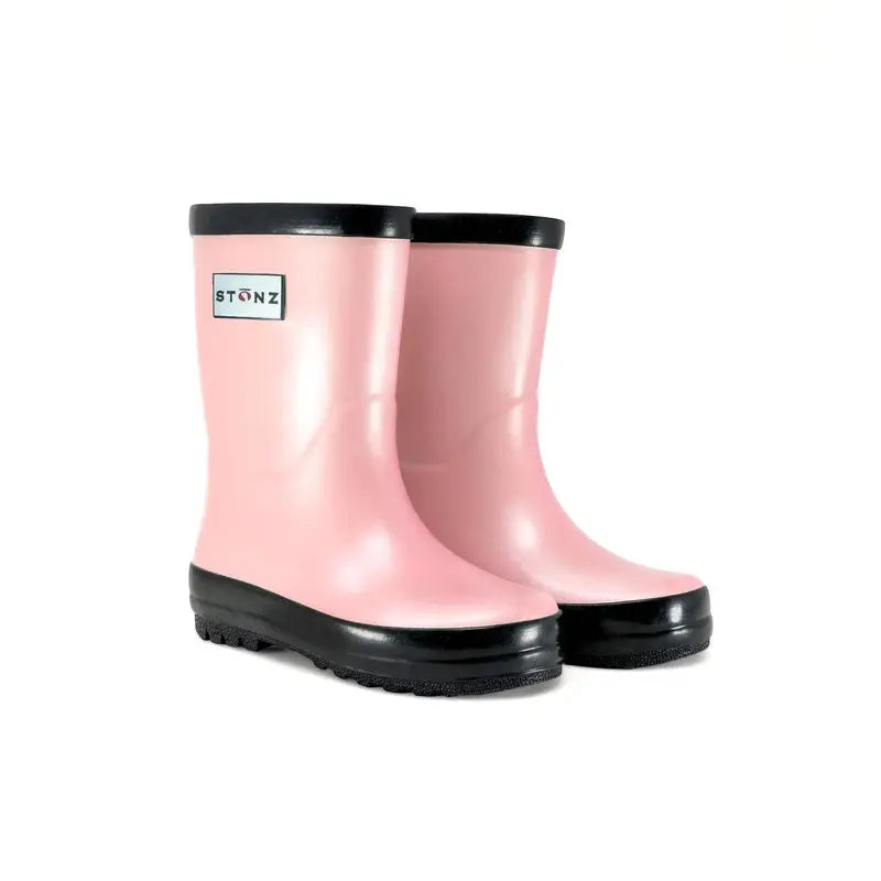 Stonz Rain Boots Metallic Haze Pink with black soles, kid waterproof boots shown as a pair ready for puddle play.