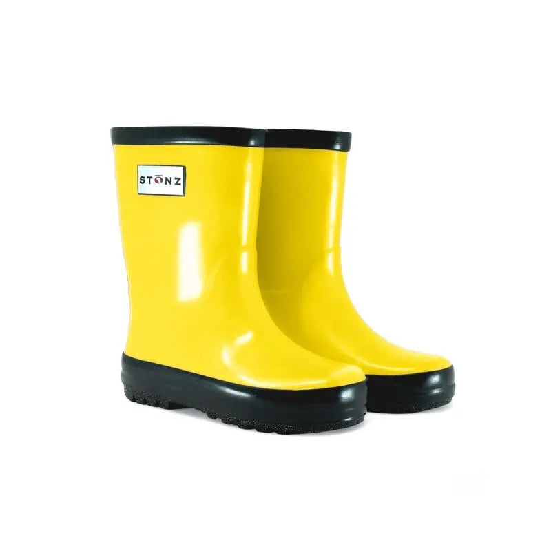 Stonz Rain Boots Yellow pair, bright yellow rubber boots with black lug soles, shown side by side.