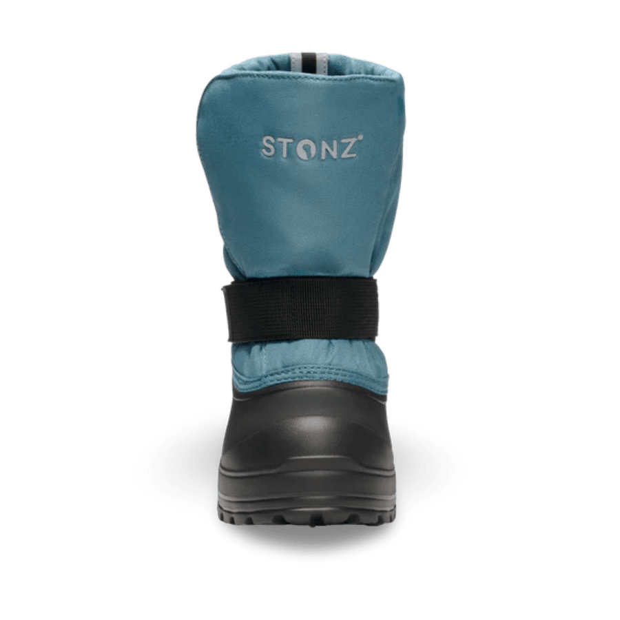Stonz Trek Kid Snow Boots Denim, blue denim upper with black ankle strap and rugged sole, back view.