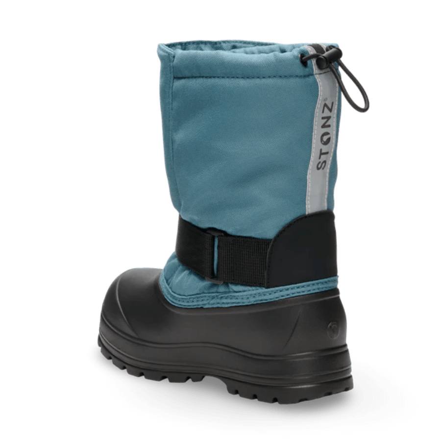 Stonz Trek Kid Snow Boots Denim, rear view: blue fabric, black rugged sole, adjustable strap, STONZ pull tab.