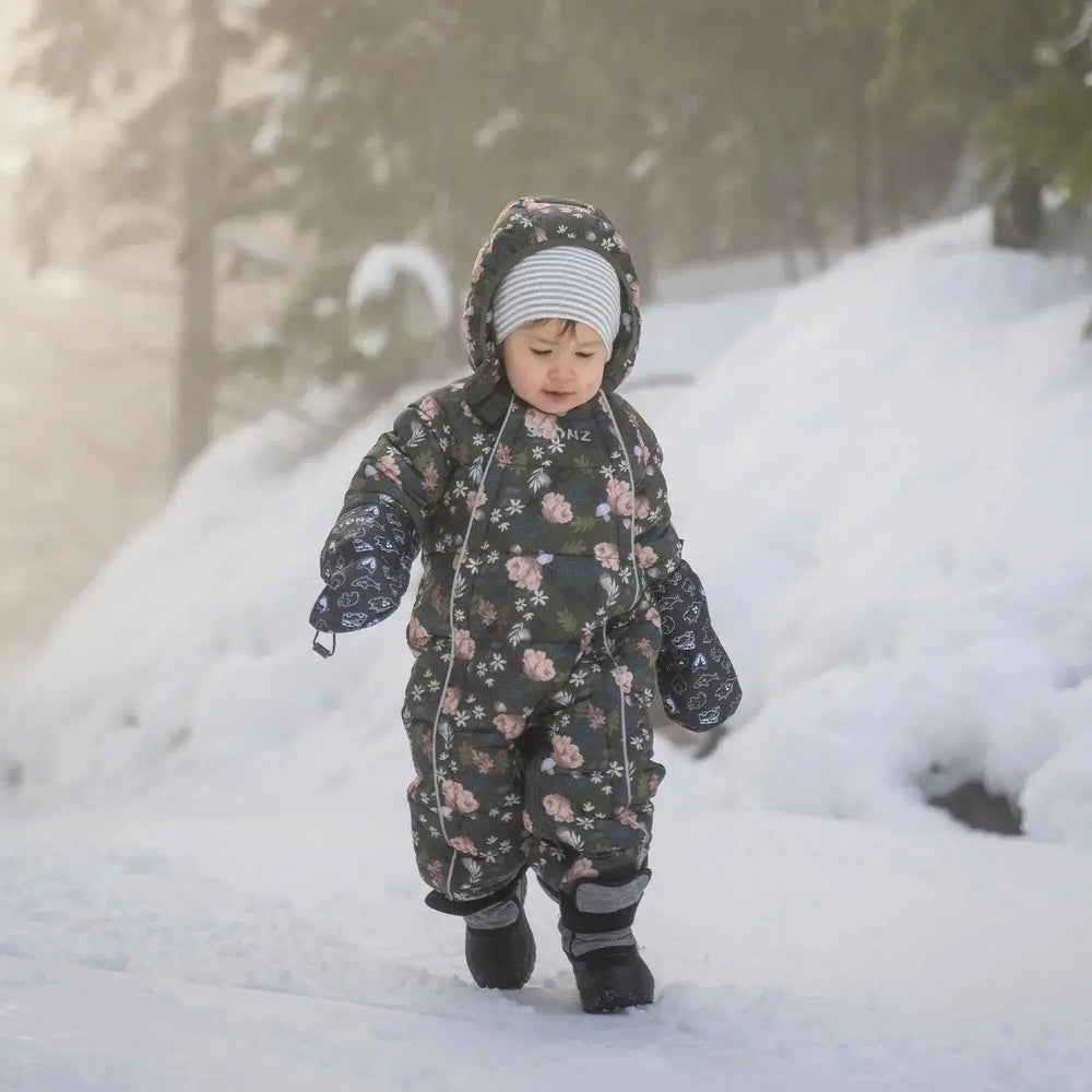 Stonz Trek Toddler Snow Boots Heather Grey worn by a toddler walking through fresh snow.