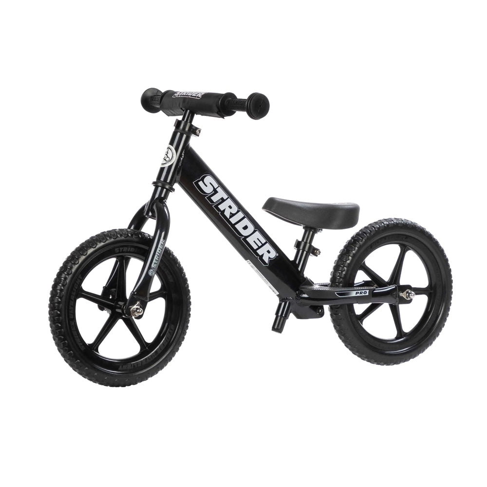 Strider 12 Pro Balance Bike in black with aluminum frame, 12-inch composite wheels, adjustable saddle, and cushioned grips