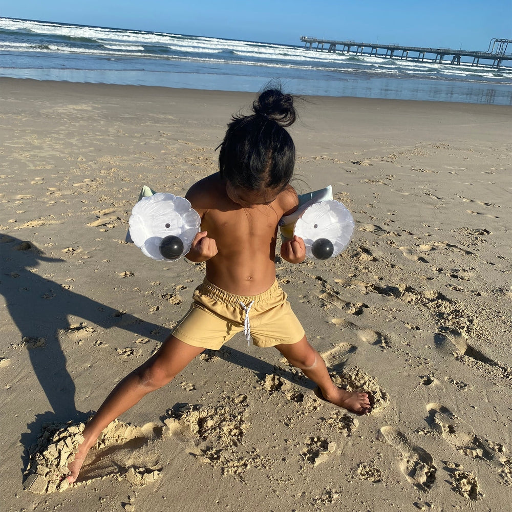 Sunnylife Monty Monster Buddy Float Bands, white with black noses, worn by child on the beach (2 bands)