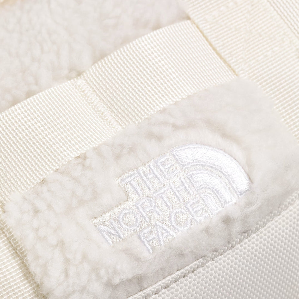 The North Face Base Camp High Pile Mini Bag in cream fleece with embroidered logo patch and beige strap