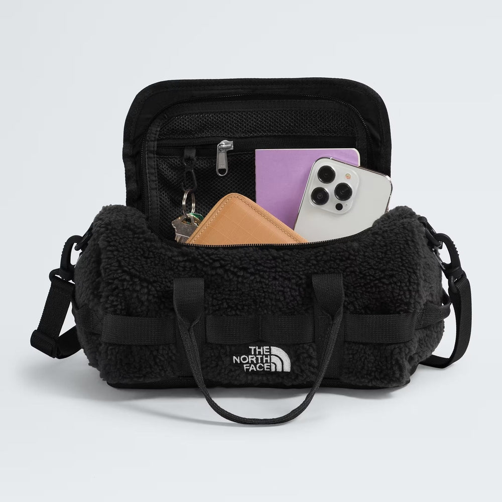 The North Face Base Camp High Pile mini bag, black fleece exterior with zip pocket and carry straps.