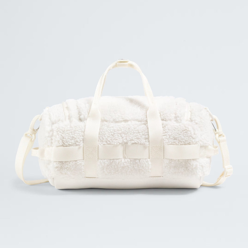 The North Face Base Camp High Pile Mini Bag, white fleece exterior with reinforced handles and adjustable strap