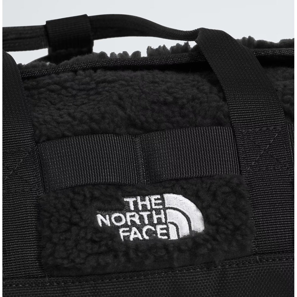 The North Face Base Camp High Pile Mini Bag in black with plush fleece interior and sturdy straps.