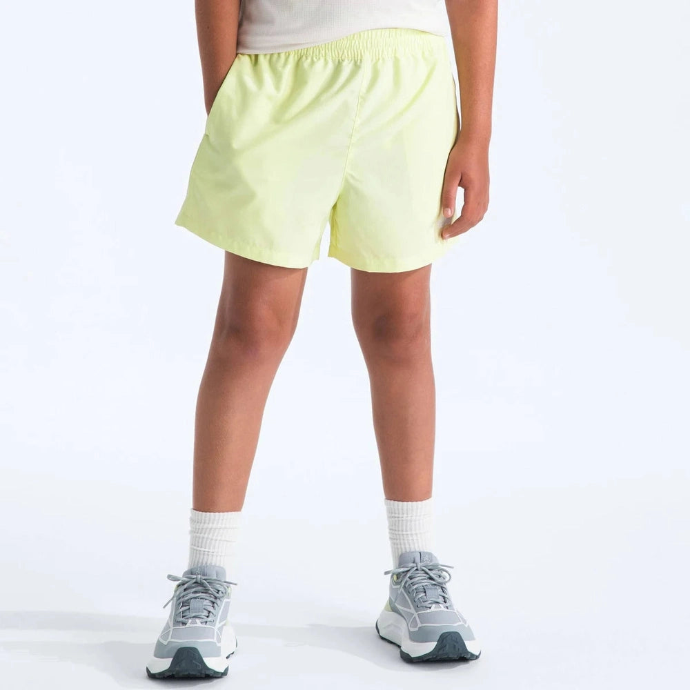 Person wearing light green shorts on a white background