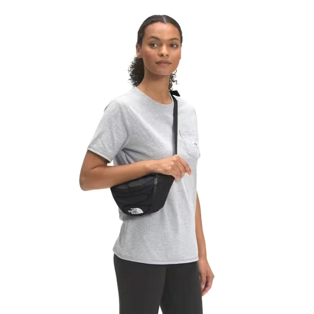 The North Face Jester Lumbar Bag in Black worn crossbody at the hip.