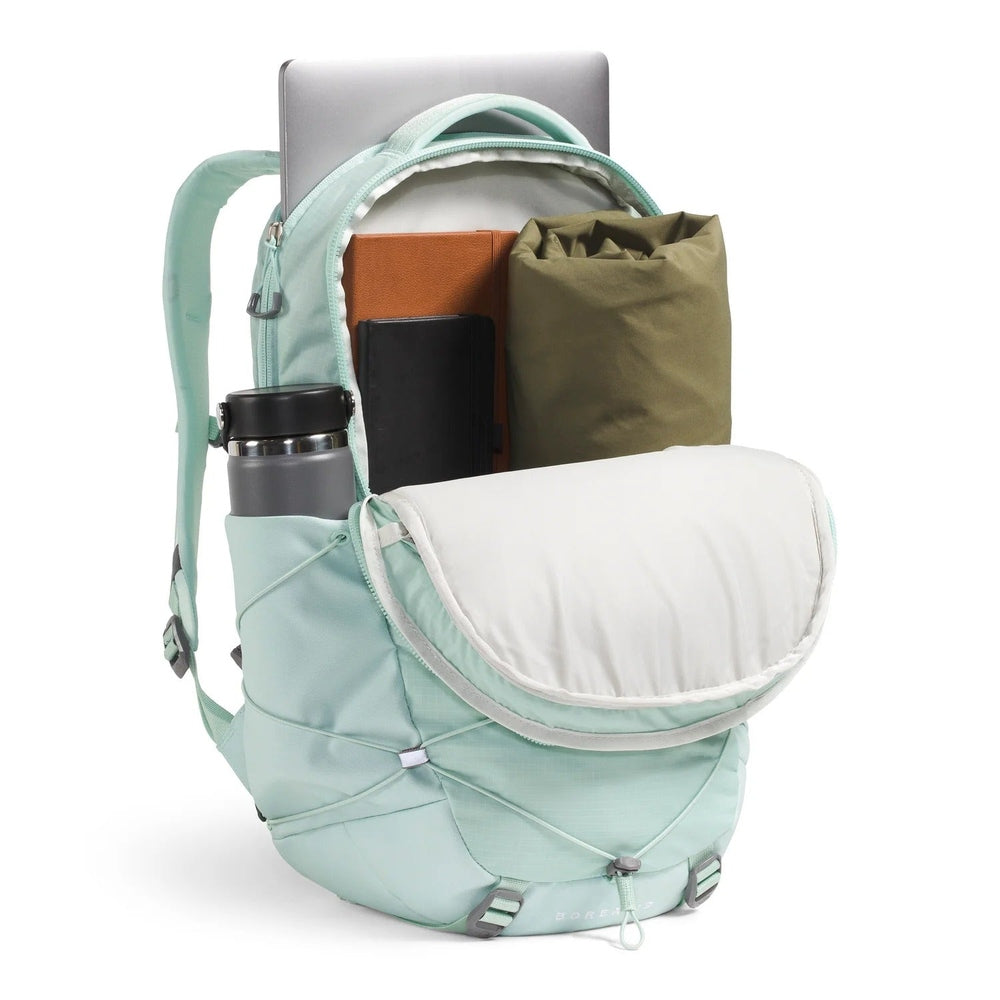 The North Face Women's Borealis Backpack in Mint Green with laptop visible.