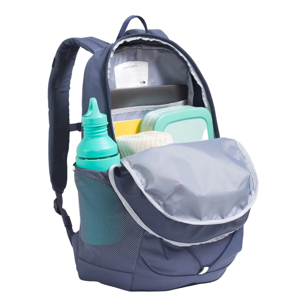 The North Face Youth Court Jester backpack in navy blue with gray lining; open main compartment shows lunchbox and mint container, side mesh bottle pocket.