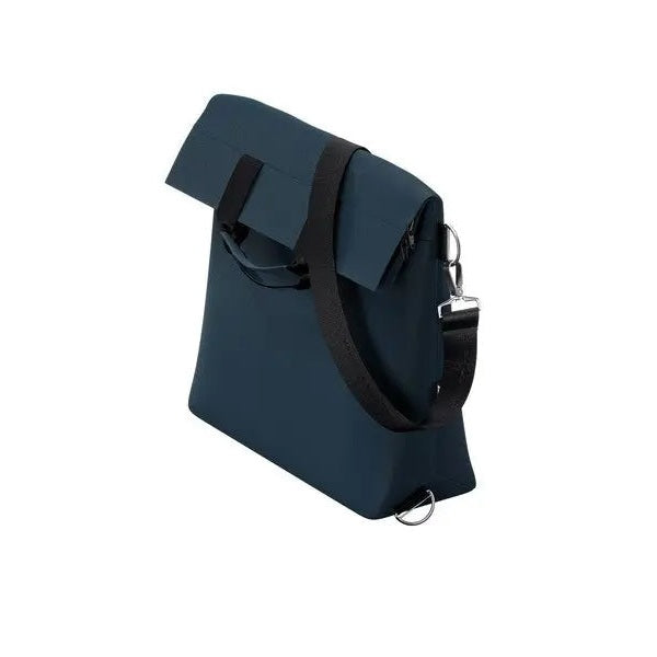 Thule Changing Bag dark blue with roll-top flap and detachable black strap, showing metal ring attachment.