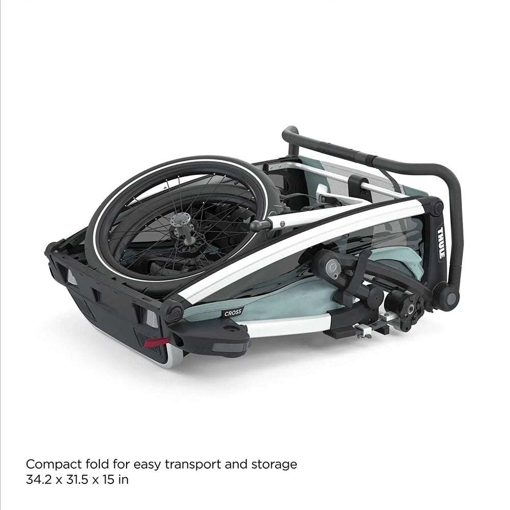 Thule Chariot Cross Multisport bike trailer in Alaska Blue, folded compactly with wheel attached for transport.