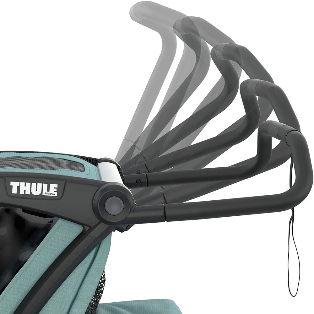 Thule Chariot Cross Multisport bike trailer in Alaska Blue; adjustable, multi-position handlebar shown in motion.