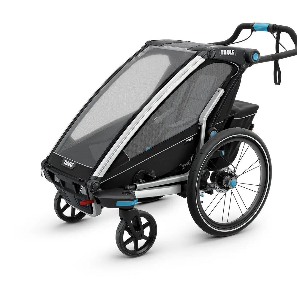 Thule Chariot Sport stroller trailer in black with blue accents, mesh canopy extended and large wheels visible.