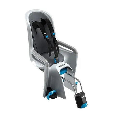 Thule RideAlong frame-mounted child bike seat in silver with black harness and blue buckle firmly attached to a bicycle frame.