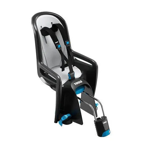 Thule RideAlong frame-mounted child bike seat attached to a bicycle frame, blue harness, and footrests.