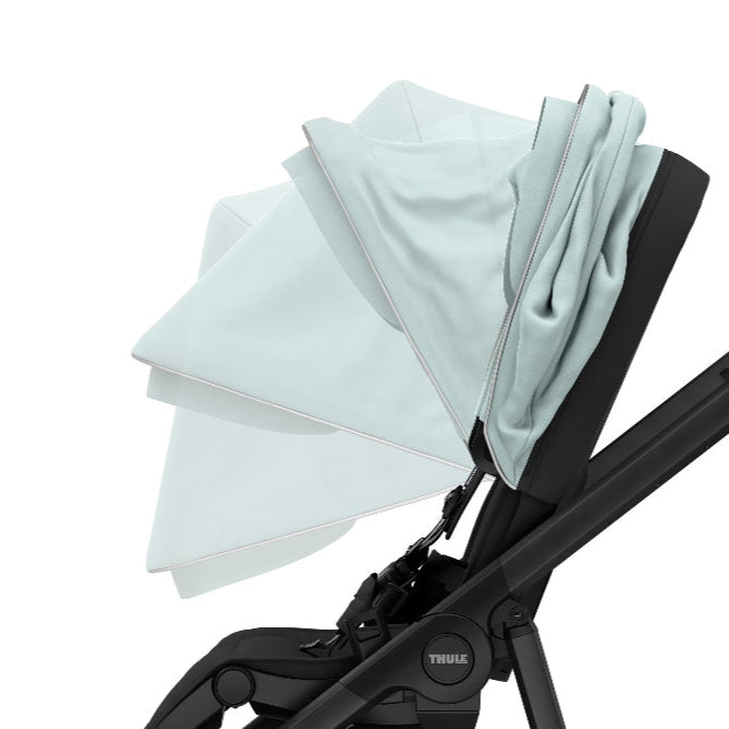 Thule Shine stroller sun canopy in light blue with a black frame for city baby transport