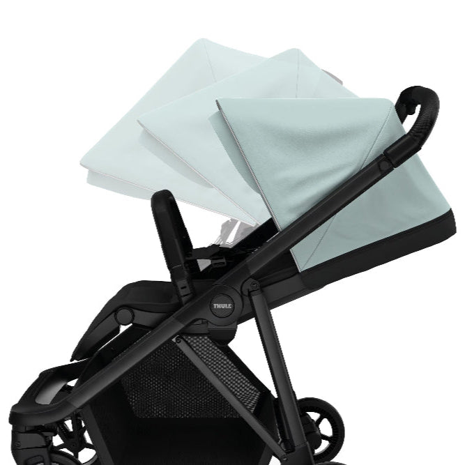 Thule Shine stroller canopy in light mint blue on a black stroller frame