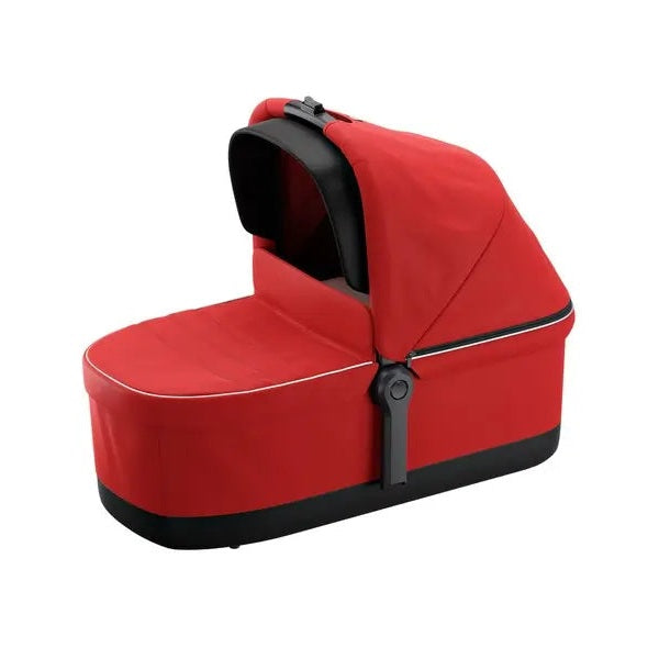 Thule Sleek Bassinet in red fabric with black base and canopy, shown securely attached to a stroller frame.