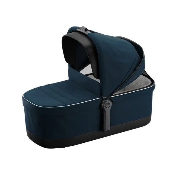 Thule Sleek Bassinet for stroller in dark blue fabric with extended canopy over padded interior.