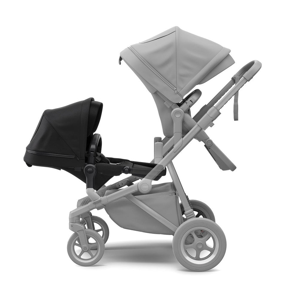 Thule Sleek Sib Seat double stroller in black/black with canopies and gray frame