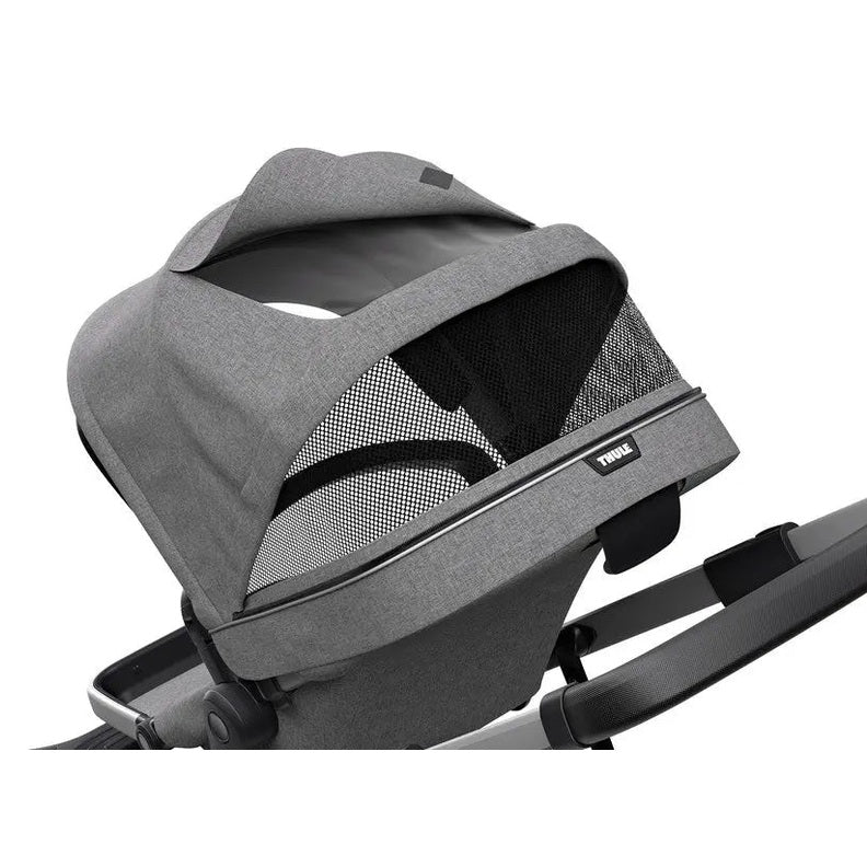 Thule Sleek Stroller bassinet in gray fabric with mesh panels, attached to a ready-to-push chassis.
