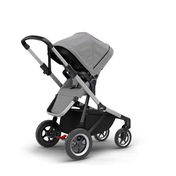 Thule Sleek Stroller in grey with black frame and extended canopy, ready for a city stroll.