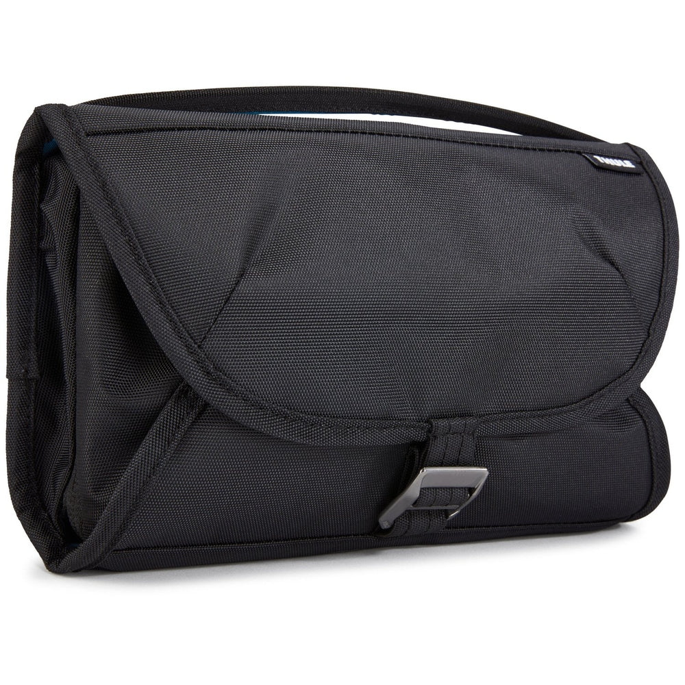 Thule Subterra toiletry bag in black fabric with top handle and front buckle closure.