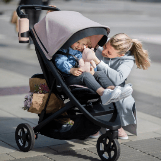 Thule Summer Seat Liner on beige stroller; keeps child cool during ride with mom beside