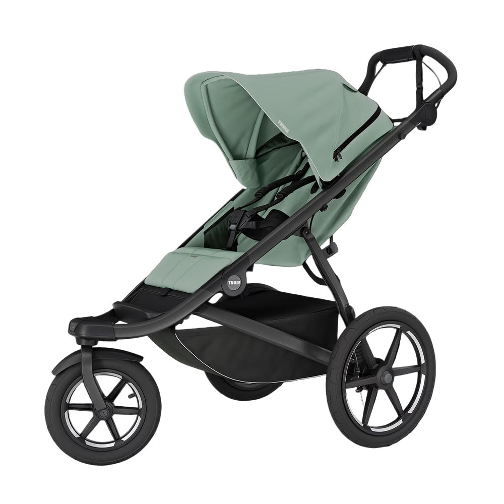 Thule Urban Glide 3 baby stroller in sage green with large canopy, black frame, and storage basket ready for a stroll.