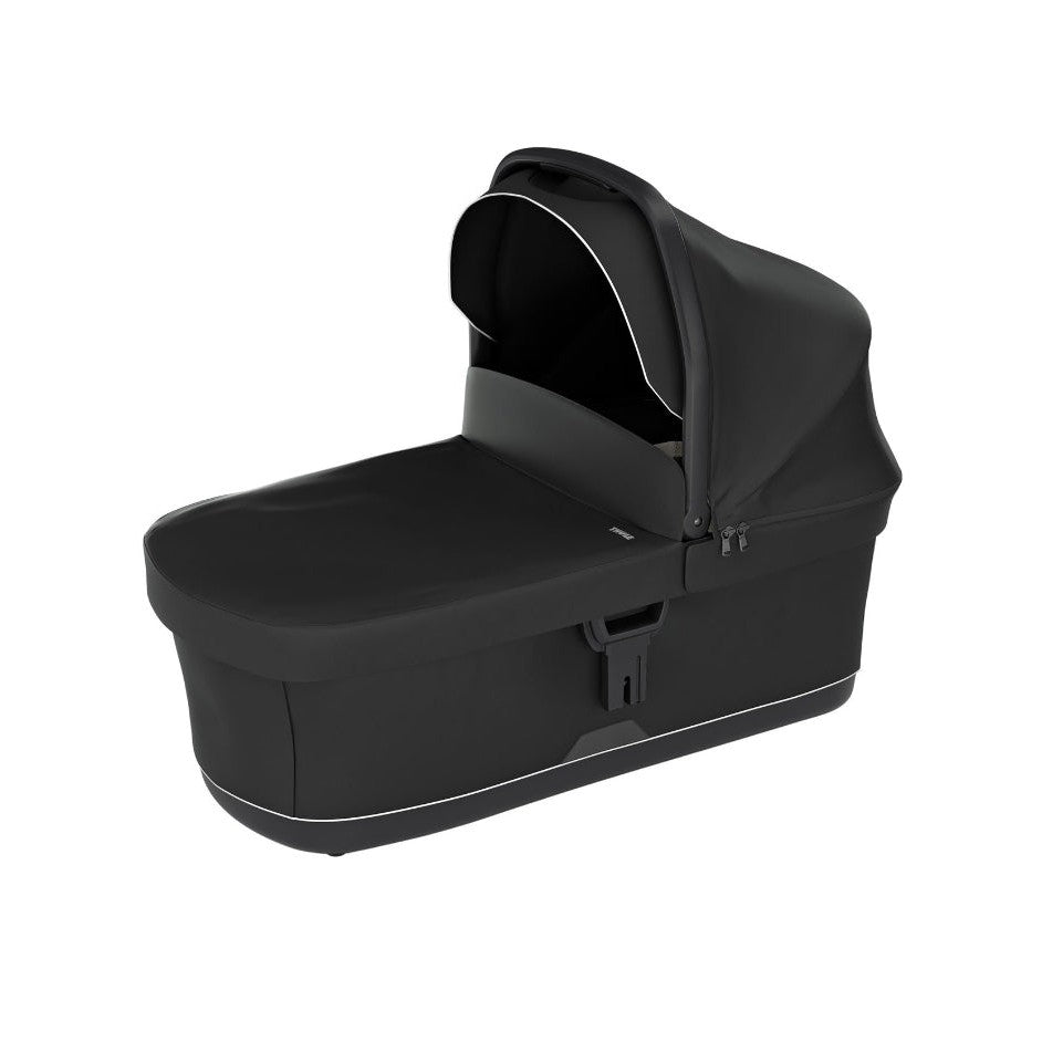 Thule Urban Glide 3 Or 4 Bassinet in black with white piping, attached to a stroller chassis.
