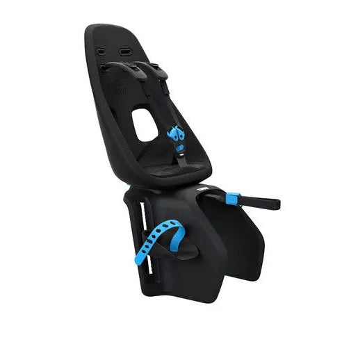Thule Yepp Nexxt Maxi child bike seat, black with blue accents, mounted on a bike frame with adjustable footrests.