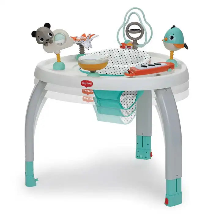 Tiny Love 5-In-1 Here I Grow stationary activity center with teal legs and colorful toys.
