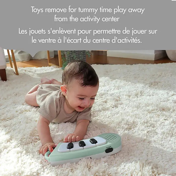 Tiny Love 5-In-1 Here I Grow Stationary Activity Center in mint/white, baby happily reaching and pressing piano keys.