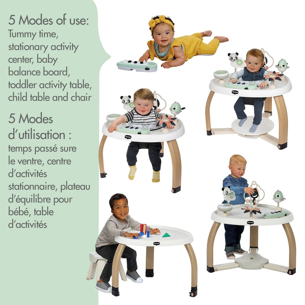 Tiny Love 5-in-1 Here Grow Stationary Activity Center with wooden legs; babies sit and play with attached toys.
