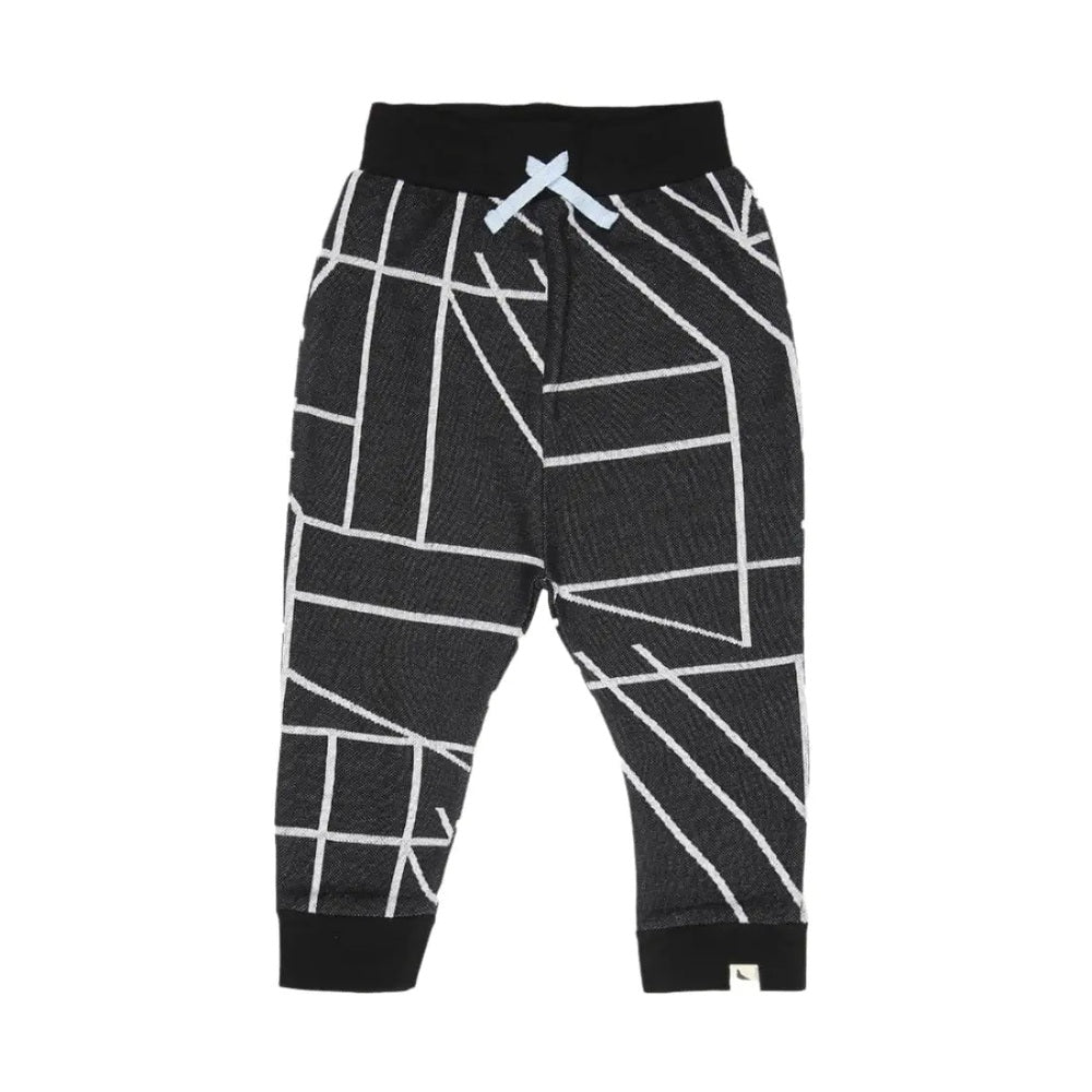 Turtledove London Geo Jacquard Harems for toddlers in black with white geometric lines and a blue drawstring tied at the waist.