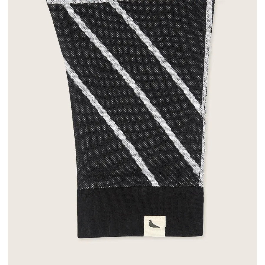 Turtledove London Geo Jacquard Harems for babies, black with white diagonal stripes, cuffed hem visible with brand tag.