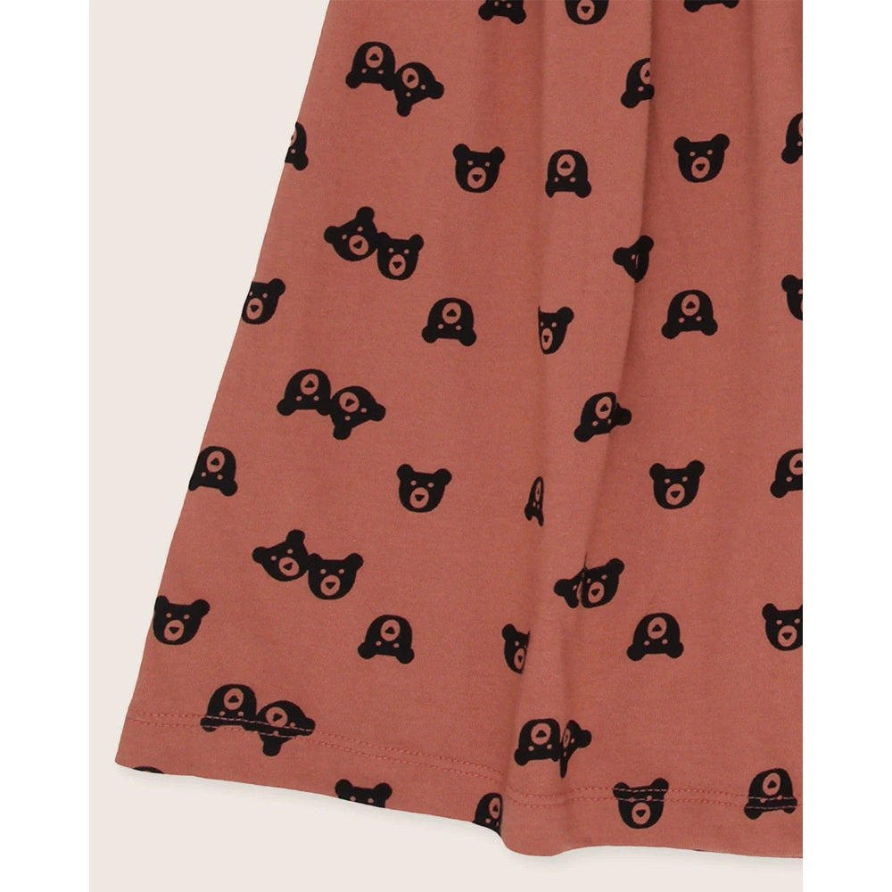 Turtledove London Two Bears Dress Sunset, rust dress with all-over black bear prints shown on soft fabric.